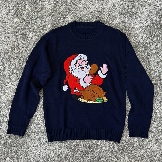 Navy blue sweater with a graphic of Santa Claus holding a turkey on a white background